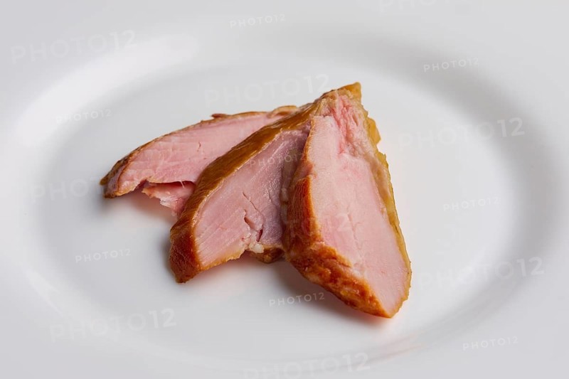 Three slices of ham on a plate