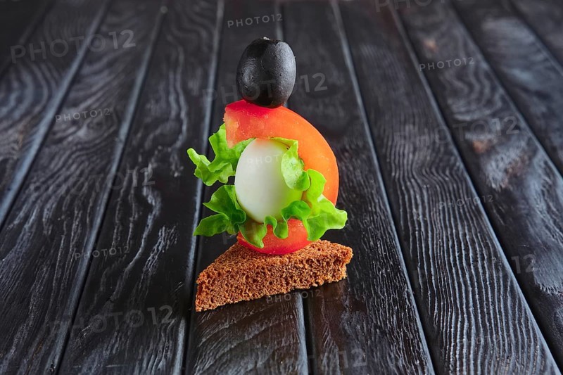 Appetizer for reception. Brown bread with quail egg