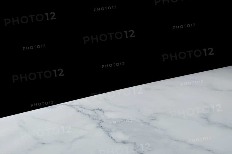 Abstract diagonal background with one part solid black and another white marble