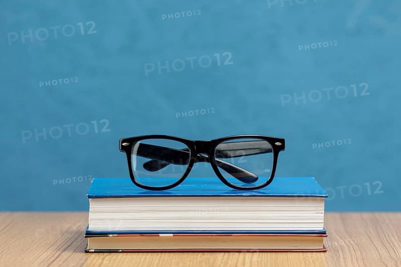 Front view books with glasses