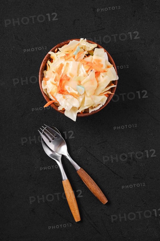Overhead view of clay bowl with homemade pickled cabbage