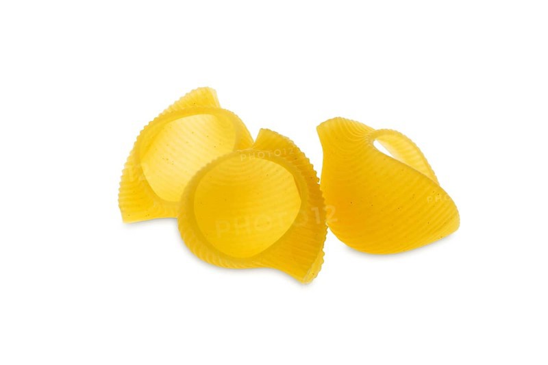 Pipe rigate pasta. Organic whole wheat grooved pipes isolated on white background