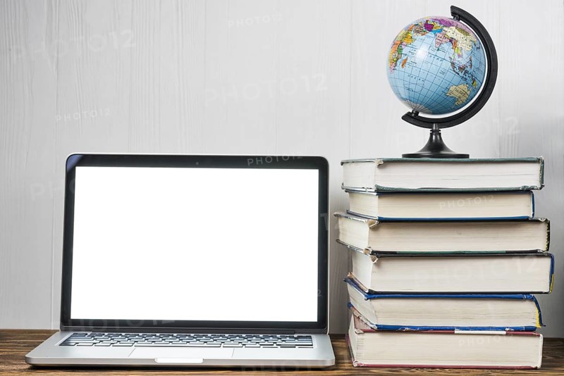Globe books near laptop
