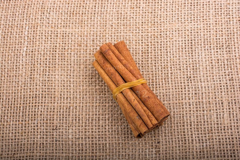 Bundle of cinnamon sticks on a linen canvas background