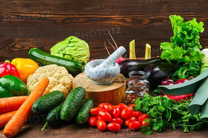 Assortment of fresh vegetables on dark wooden background