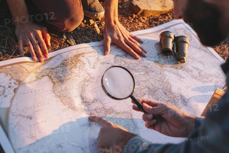 Crop man exploring map