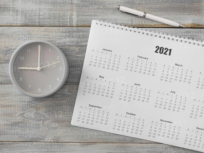 Flat lay desk calendar and analog clock