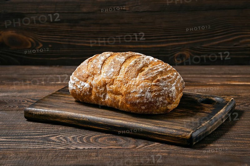 Artisan whole grain wheat bread on wooden board
