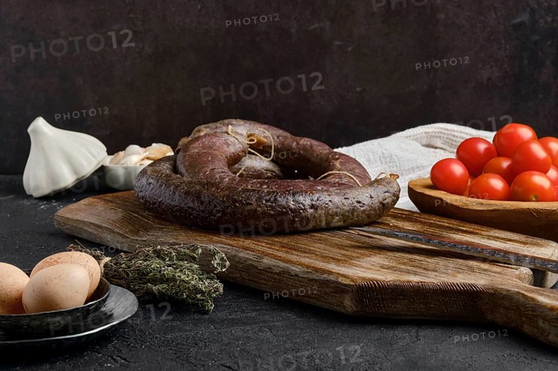 Blood sausage rolled on wooden cutting board