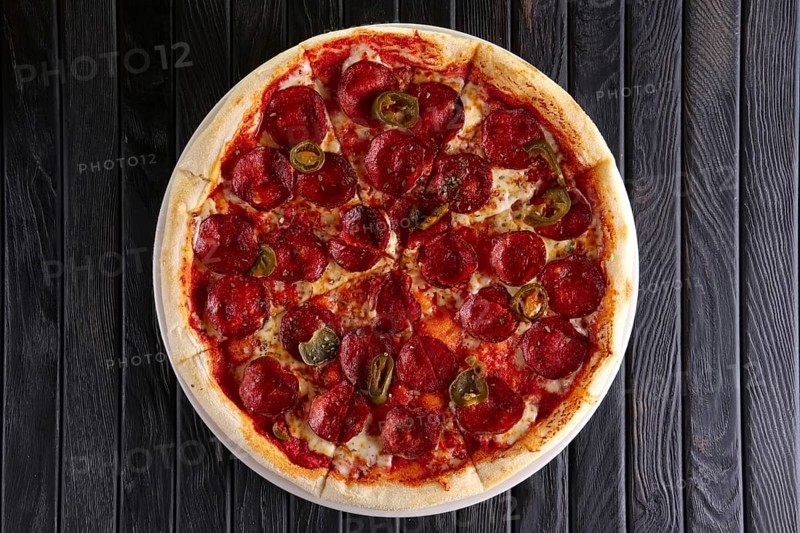 Hot pizza pepperoni with jalapeno pepper. Top view