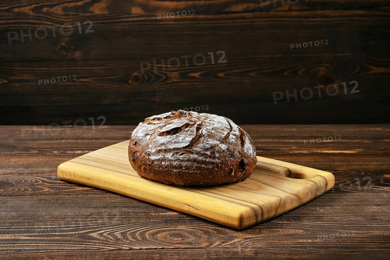 Fresh rye brown bread on wooden cutting board