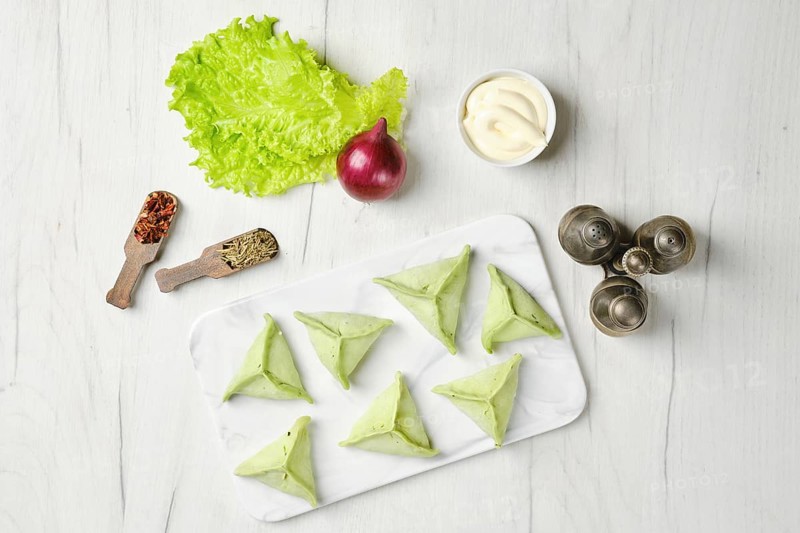 Overhead view of frozen dumplings with spinach