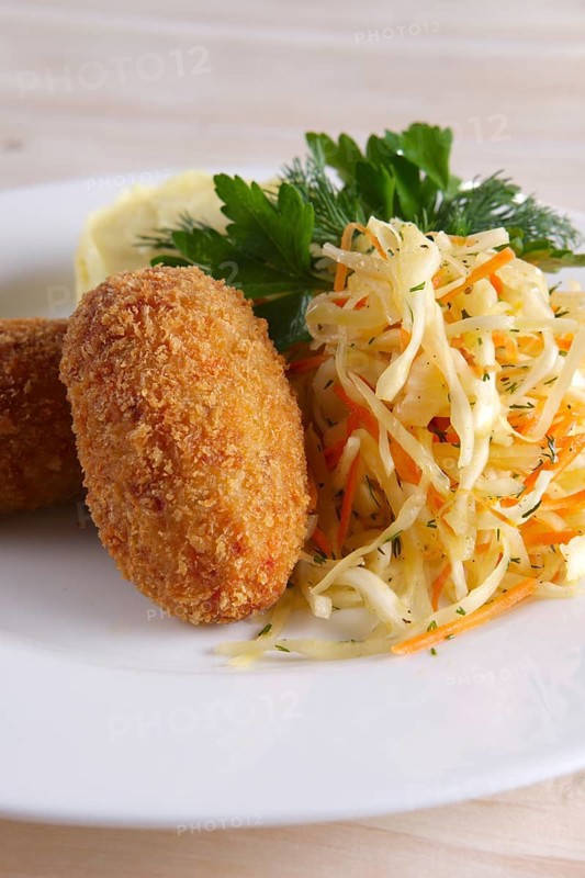 Chicken Kiev cutlet with pickled cabbage and mashed potato