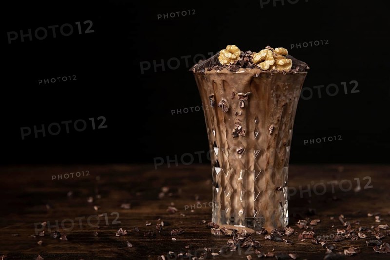 Close up view chocolate milkshake with walnuts