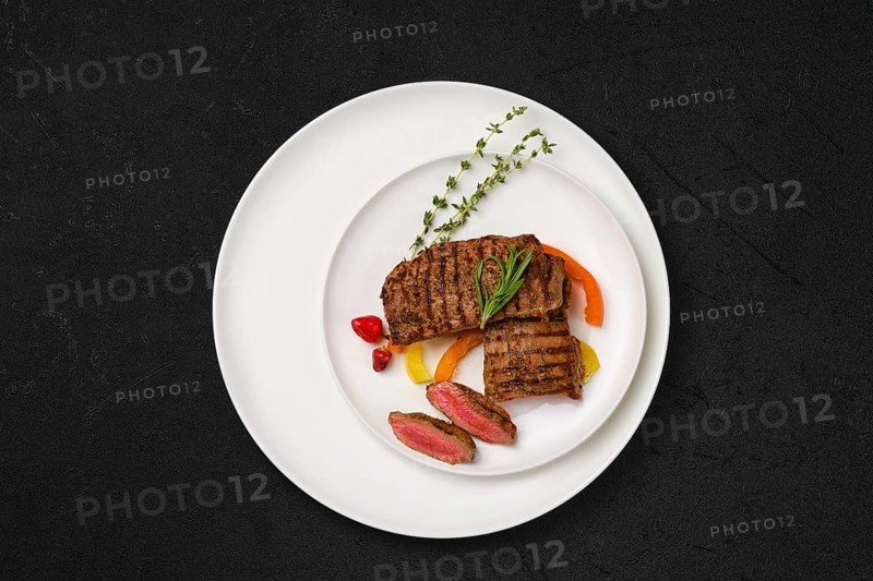 Grilled lamb steaks cut on slices on a plate
