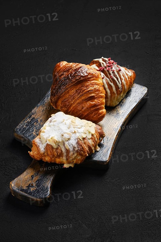 Assortment of crispy croissants on serving board