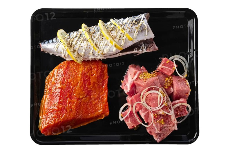 Marinated varieties of meat and fish ready for grilling isolated on white background