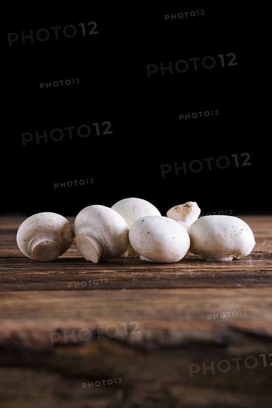 Fresh champignon on wooden background