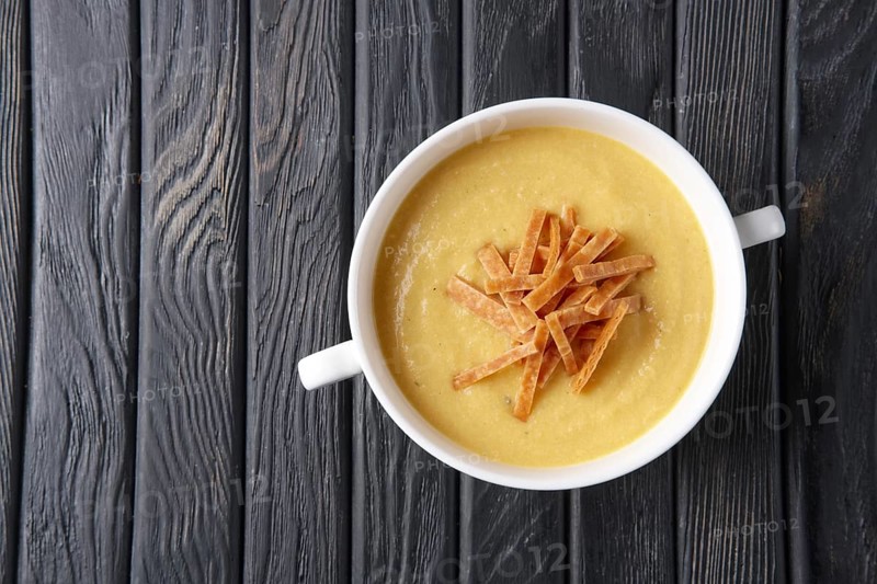Top view of punpkin soup puree with chips