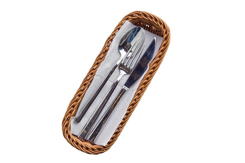 Set of cutlery in basket isolated on white background