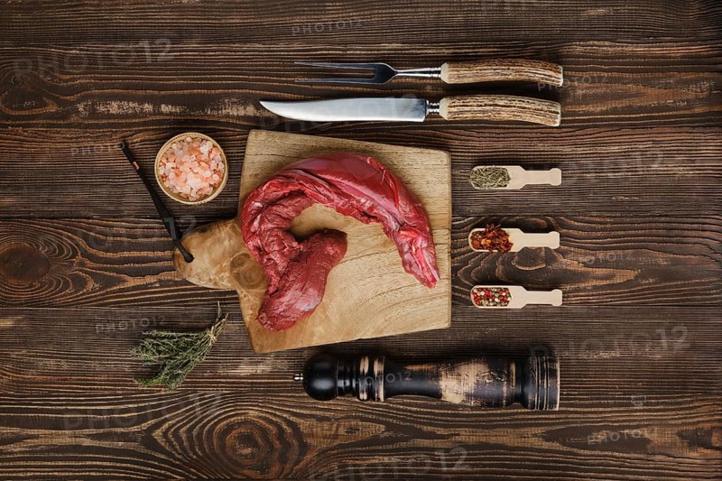 Overhead view of raw fresh top round beef strip with spices