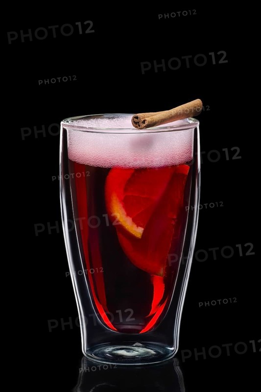 Double-walled glass with hot mulled wine isolated on black