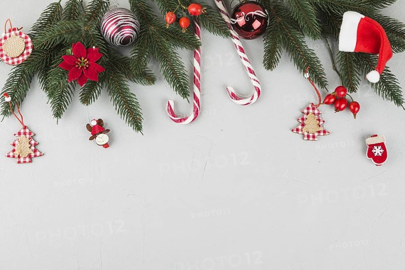 Green fir tree branches with candy canes small toys