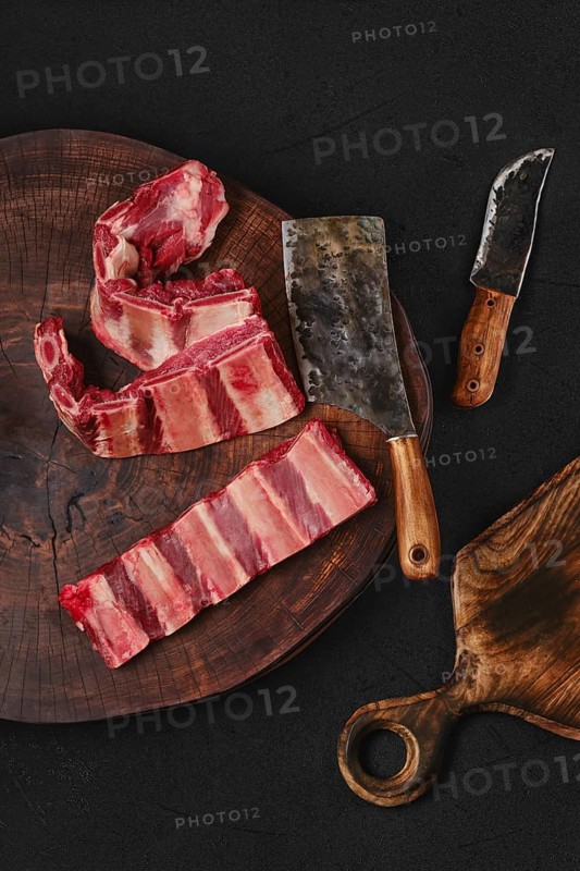 Raw fresh beef short rib stripes on wooden chopping slab
