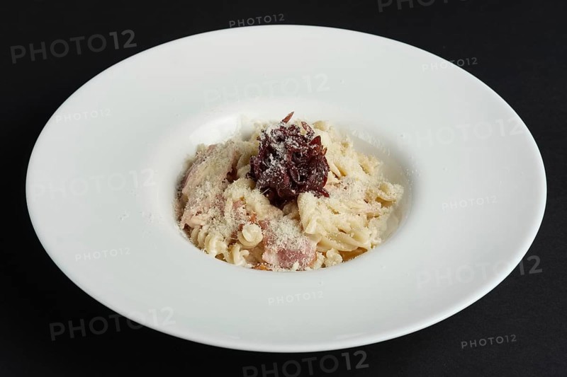 Plate of pasta with salmon and onion marmalade
