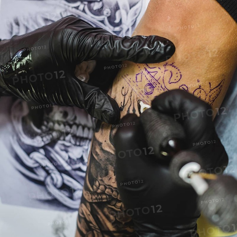 Hands gloves doing tattoo