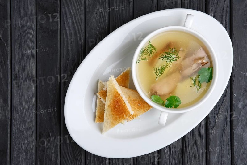 Clear beef broth with egg and toasts