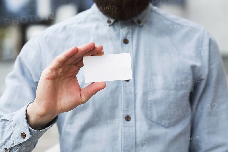 Close up businessman s hand showing white blank visiting card