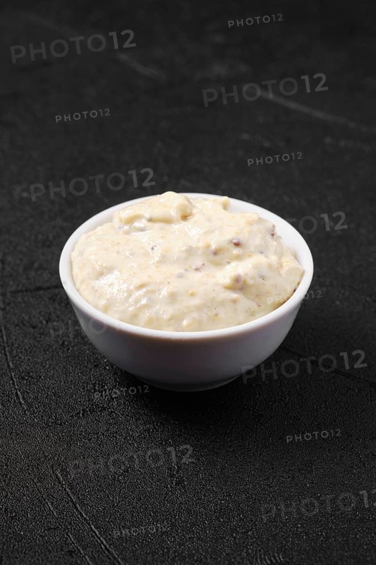 Small bowl with caesar sauce for salad