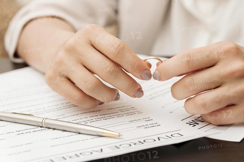 Close up hands holding wedding ring