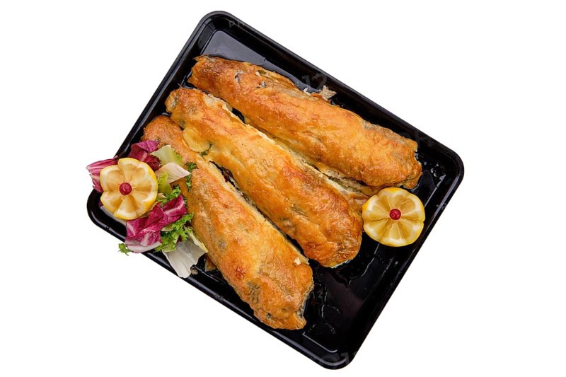 Baked fish in batter on tray isolated on white