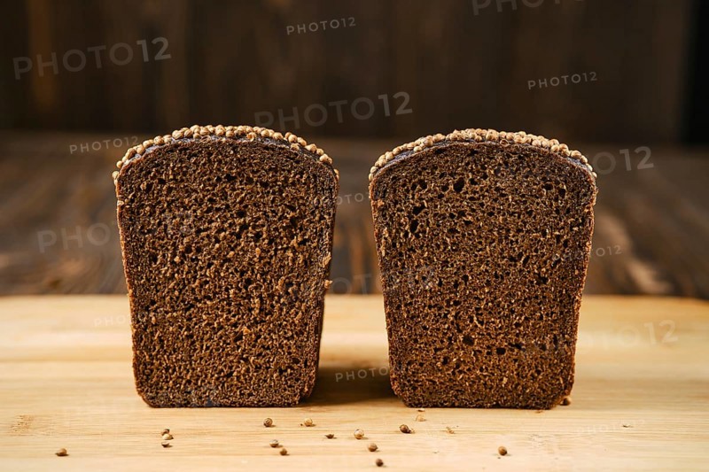 Closeup view of fresh rye brown bread on wooden cutting board