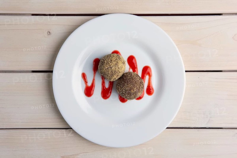 Chocolate truffles with biscuit powder. Rum balls and raspberry jam. Top view