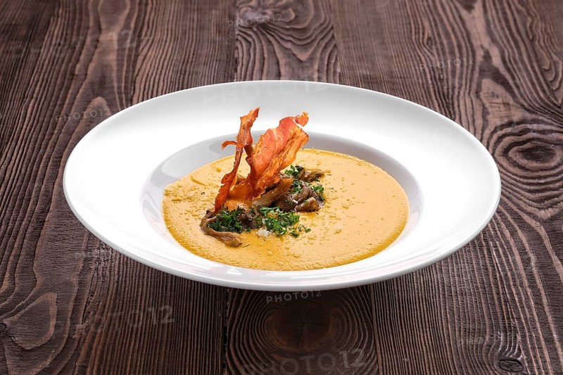 Mashed pumpkin soup puree with bacon