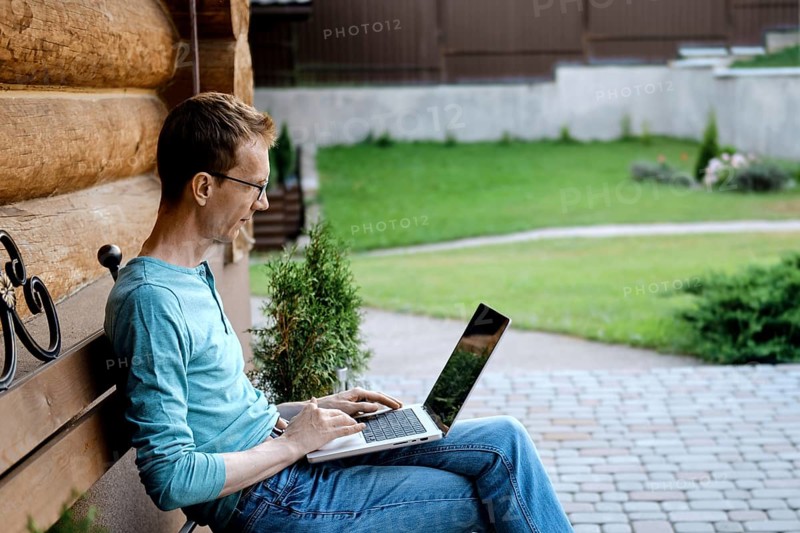 Middle aged man making video call outdoors