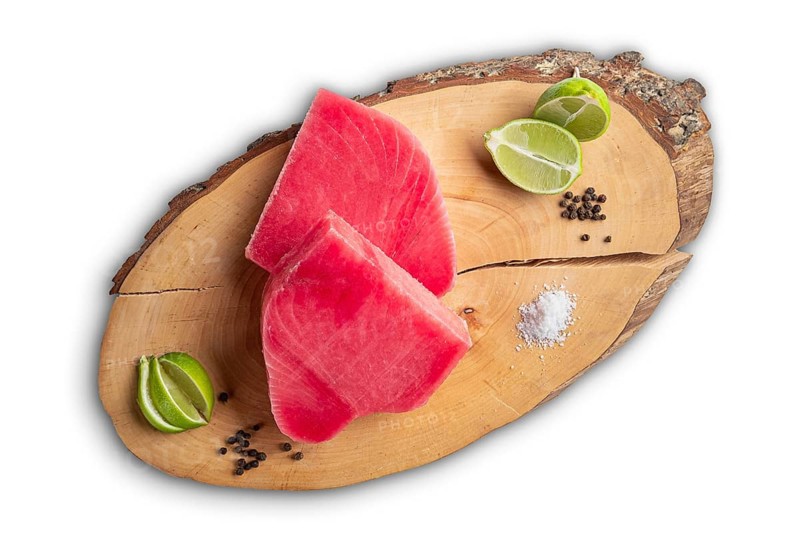 Fresh raw tuna steak on wooden cutting board