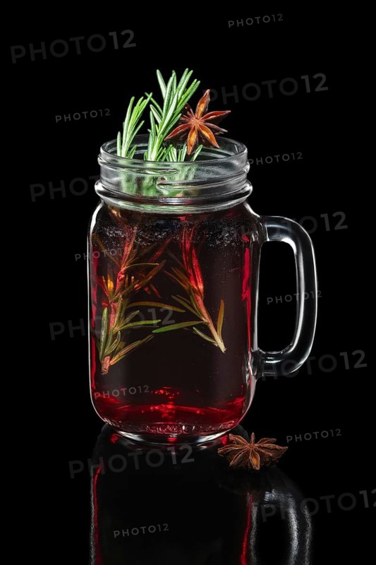 Hot cherry tea with cinnamon and rosemary in mason jar