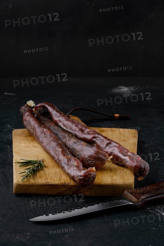 Dry cured beef sausage on cutting board