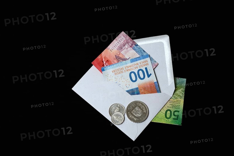 Swiss banknotes and coins with envelope