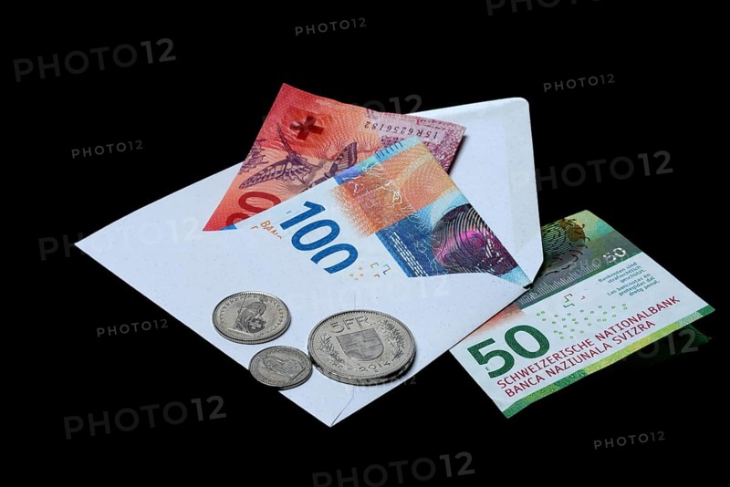 Swiss banknotes and coins with envelope