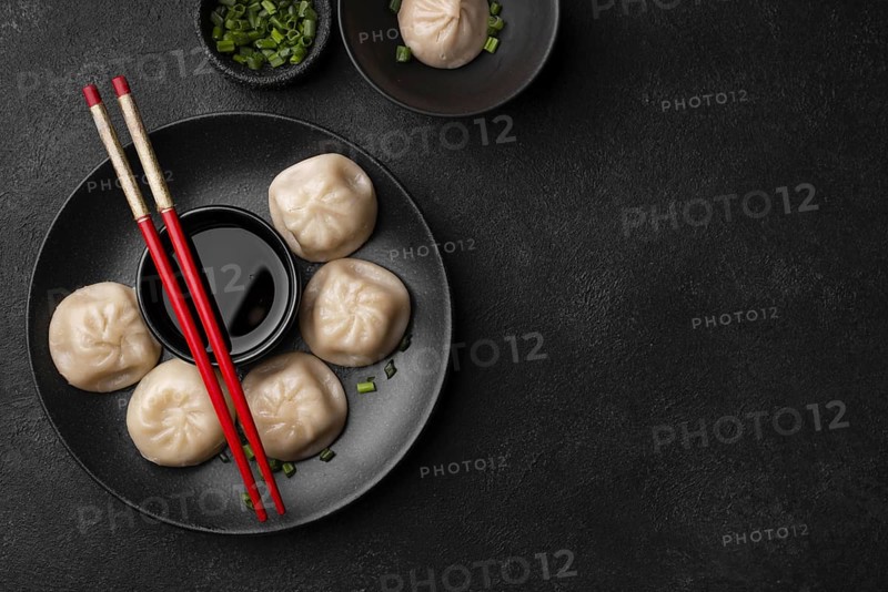 Flat lay asian dumplings with chopsticks copy space