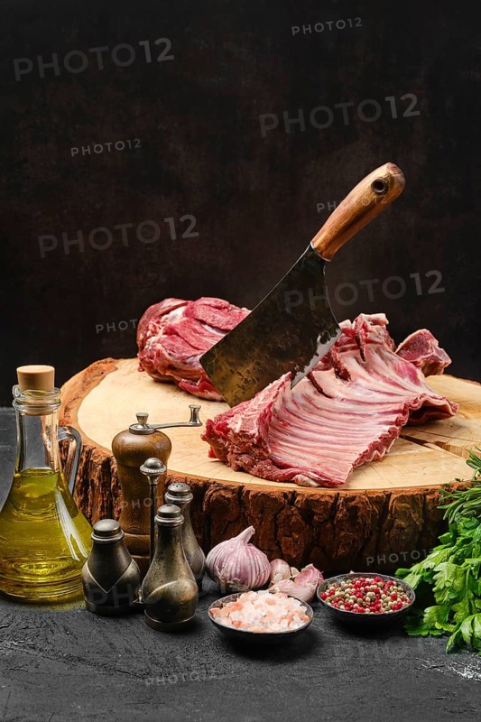 Raw lamb ribs and shoulder on butcher stump