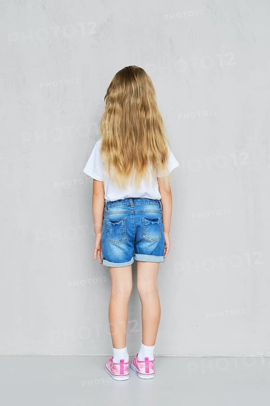 Back view of little child girl in white t-shirt
