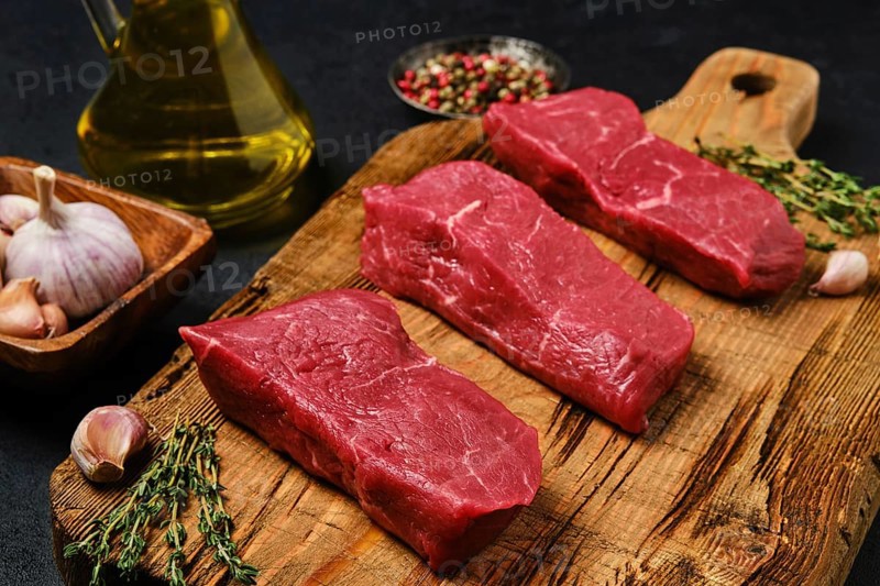 Closeup view of raw boneless strip steak loin with spice