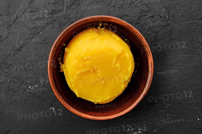 Homemade rustic melted butter and small cast iron skillet