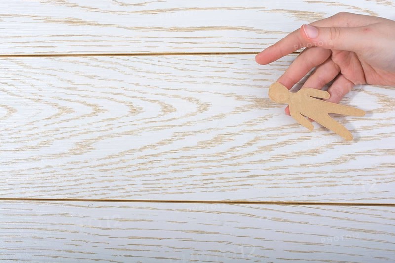 Man shape cut out of paper in hand in the view